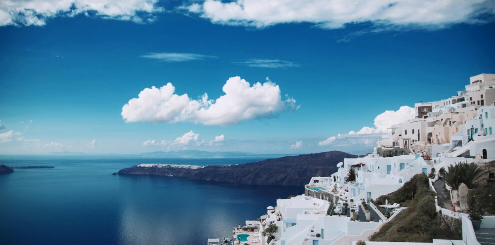 White houses of Santorini Greece overlooking the Aegean Sea under blue sky
