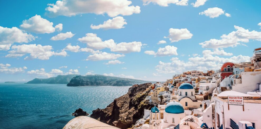 Oia village Santorini Greece white houses and blue domes overlooking the Aegean Sea