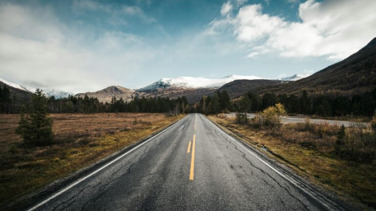 Scenic Mountain Road Leading to Snowy Peaks