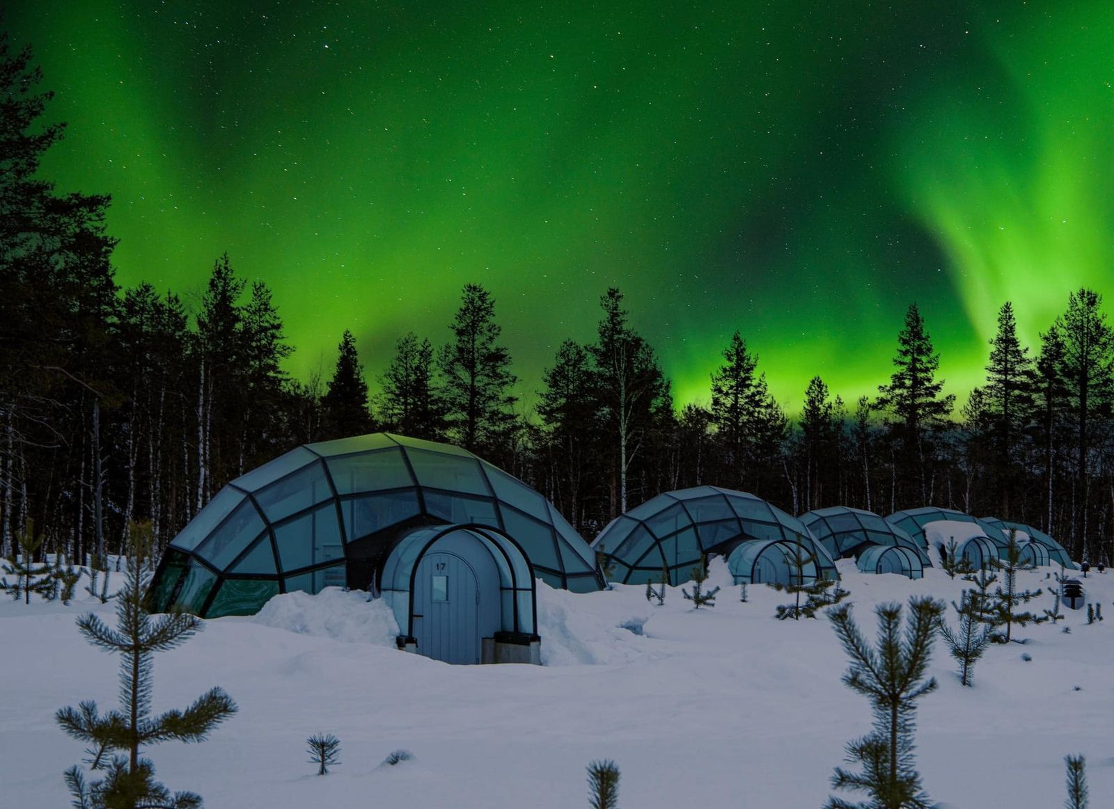 Luxury glass igloos beneath the Northern Lights in Finnish Lapland, featured in the Iceland & Lapland tour by Aviana Holidays.